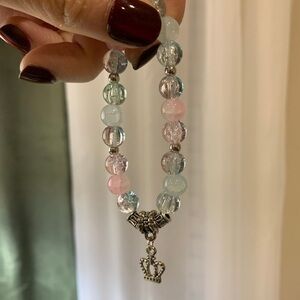 Pink and blue beaded bracelet with crown charm